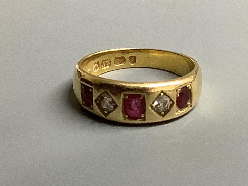 A late Victorian 18ct gold and gypsy set three stone ruby and two stone diamond half hoop ring